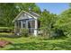 Charming home with a screened front porch, landscaped yard, and mature trees creating a welcoming curb appeal at 850 Fourth St, Stone Mountain, GA 30083