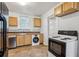 The kitchen has tile floors, wood cabinets, and stainless steel dishwasher and oven at 850 Fourth St, Stone Mountain, GA 30083