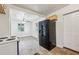 The kitchen features a black refrigerator, tile floor, and neutral paint at 850 Fourth St, Stone Mountain, GA 30083