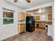 This kitchen features tile floors, a window over the sink, and wood cabinets at 850 Fourth St, Stone Mountain, GA 30083