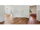 Bright living room with hardwood floors, a decorative fireplace, and an open doorway to other rooms at 850 Fourth St, Stone Mountain, GA 30083