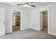 Living room with neutral carpet, ceiling fan, and views to kitchen and bedroom at 850 Fourth St, Stone Mountain, GA 30083