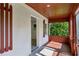 View of porch with dark wood trim, red painted floor and access to interior at 850 Fourth St, Stone Mountain, GA 30083