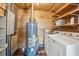 Utility room featuring a modern washer and dryer, shelving, and a water heater at 850 Fourth St, Stone Mountain, GA 30083