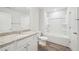 Bathroom featuring a granite countertop, shower with tub, and wooden floors at 1452 Stephens View Dr, Loganville, GA 30052