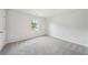 A bedroom features carpet flooring and a window with a backyard view at 1452 Stephens View Dr, Loganville, GA 30052