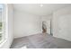 Spacious bedroom features neutral carpet, white trim, and a large window at 1452 Stephens View Dr, Loganville, GA 30052
