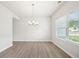 Bright dining room featuring a modern chandelier and large window at 1452 Stephens View Dr, Loganville, GA 30052
