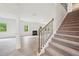 Inviting entryway featuring carpeted stairs and an open view into the living area at 1452 Stephens View Dr, Loganville, GA 30052