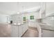 Bright, modern kitchen with granite countertops, white cabinetry, and stainless steel appliances at 1452 Stephens View Dr, Loganville, GA 30052
