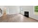 Bright living room with a cozy fireplace and views of the outdoors at 1452 Stephens View Dr, Loganville, GA 30052