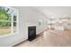 Spacious living area featuring a fireplace, with a modern kitchen in the background at 1452 Stephens View Dr, Loganville, GA 30052