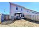 Fenced backyard featuring an outdoor seating area, grill and string lights at 2132 Arnage Dr, Lithonia, GA 30058