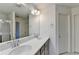 Bright bathroom featuring dual sinks and a shower with glass door at 2132 Arnage Dr, Lithonia, GA 30058