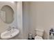 A modern half bath features a pedestal sink and tiled floor at 2132 Arnage Dr, Lithonia, GA 30058