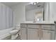 Bright bathroom featuring a gray vanity, toilet and tub and shower combination at 2132 Arnage Dr, Lithonia, GA 30058