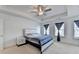 Bright bedroom with plush carpet, a queen bed, and curtains over three windows at 2132 Arnage Dr, Lithonia, GA 30058