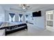 Large bedroom with a tray ceiling, ceiling fan, and bathroom access at 2132 Arnage Dr, Lithonia, GA 30058