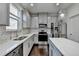 Bright kitchen featuring stainless steel appliances, gray cabinets, a center island, and hardwood floors at 2132 Arnage Dr, Lithonia, GA 30058