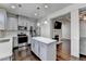 Modern kitchen with a center island, stainless steel appliances, and a view into the living room at 2132 Arnage Dr, Lithonia, GA 30058