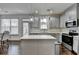 Modern kitchen featuring stainless steel appliances, a center island, and grey cabinetry at 2132 Arnage Dr, Lithonia, GA 30058