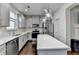 Stylish kitchen featuring a center island, stainless steel appliances, gray cabinets, and hardwood floors at 2132 Arnage Dr, Lithonia, GA 30058