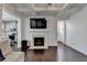 Open-concept living room featuring a fireplace, hardwood floors and easy access to the kitchen at 2132 Arnage Dr, Lithonia, GA 30058