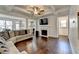 Bright living room with coffered ceiling, fireplace and hardwood floors open to the kitchen at 2132 Arnage Dr, Lithonia, GA 30058