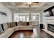 Bright living room with coffered ceiling, fireplace, and hardwood floors connected to kitchen at 2132 Arnage Dr, Lithonia, GA 30058