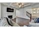 Bright living room featuring a fireplace, coffered ceiling, hardwood floors and a staircase to the upper level at 2132 Arnage Dr, Lithonia, GA 30058