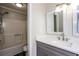 Bright bathroom features a shower-tub combo, white quartz countertop, updated mirror and neutral color palette at 3474 Kingswood Run, Decatur, GA 30034
