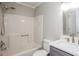 Bright bathroom features a shower-tub combo, white quartz countertop, updated mirror and neutral color palette at 3474 Kingswood Run, Decatur, GA 30034