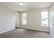 Spacious bedroom featuring two windows and neutral carpet and paint at 3474 Kingswood Run, Decatur, GA 30034