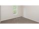 This bedroom has neutral walls and carpet along with natural light coming from the double hung windows at 3474 Kingswood Run, Decatur, GA 30034