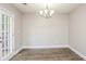 Dining room with hardwood floors, a modern light fixture, and access to the backyard at 3474 Kingswood Run, Decatur, GA 30034