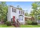 Charming home with a red door, bay window and stairs to the front door entrance at 3474 Kingswood Run, Decatur, GA 30034