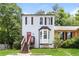 Charming home featuring a red front door, bay window, and elevated front porch at 3474 Kingswood Run, Decatur, GA 30034