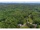 Expansive wooded acreage featuring a home and barn accessible by winding dirt road at 6605 Old White Mill Rd, Fairburn, GA 30213