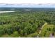 Vast expanse of lush green forest and trees in the background offers the perfect blend of natural beauty at 6605 Old White Mill Rd, Fairburn, GA 30213