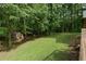 Large backyard of log home with well-kept grass and a shed on the rear property line at 6605 Old White Mill Rd, Fairburn, GA 30213
