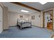 Finished basement bedroom features neutral walls, blue carpet and exposed beam at 6605 Old White Mill Rd, Fairburn, GA 30213