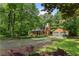 Scenic view of log cabin with covered front porch and two-car attached garage at 6605 Old White Mill Rd, Fairburn, GA 30213