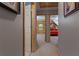Hallway view showing access to multiple rooms with doors and a glimpse of a bedroom at the end at 6605 Old White Mill Rd, Fairburn, GA 30213