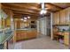 Well-lit kitchen boasting stainless steel appliances, wood walls, and seamlessly integrates with other living spaces at 6605 Old White Mill Rd, Fairburn, GA 30213