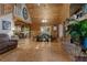 Open living room with wood walls, wood floor, dining table, fire place and access to a kitchen at 6605 Old White Mill Rd, Fairburn, GA 30213