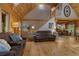 Inviting living room with wood walls, wood floor and comfortable seating creating a cozy and warm atmosphere at 6605 Old White Mill Rd, Fairburn, GA 30213