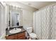 Bathroom with a dark countertop vanity, toilet and shower with glass doors at 701 Fir Chase, Fairburn, GA 30213