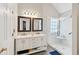 Bathroom with marble counter tops, white cabinets, dual vanity and a marble walled shower at 701 Fir Chase, Fairburn, GA 30213