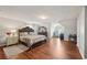 Large bedroom featuring hardwood floors, decorative furniture, and a cozy bed for relaxation and comfort at 701 Fir Chase, Fairburn, GA 30213