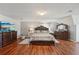 Spacious bedroom featuring hardwood floors, decorative furniture, and a cozy bed for relaxation and comfort at 701 Fir Chase, Fairburn, GA 30213